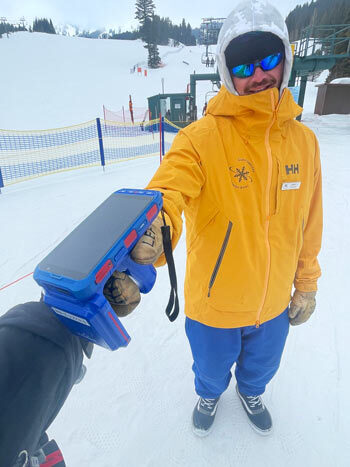 Lift operator scanning a skiiers pass